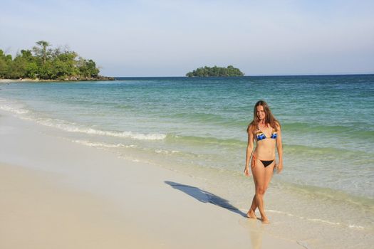 Young woman walking on a beach of Koh Rong island, Cambodia, Southeast Asia