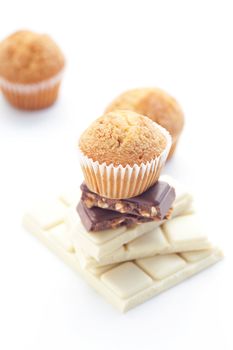 bar of chocolate and muffin isolated on white