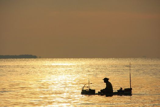 Silhouette of fisherman at sunrise, Gulf of Thailand, Cambodia, Southeast Asia