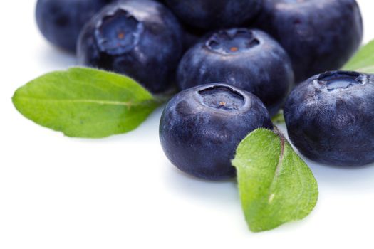 blue berry over white background and green leaf