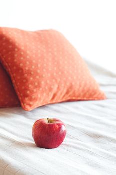 apple on the bed with two pillows