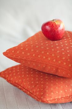 apple lying on pillows on the bed