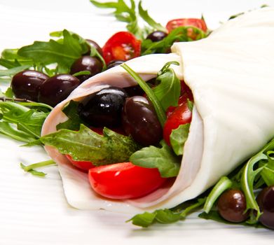mozzarella roll with tomatoes,olives and salad