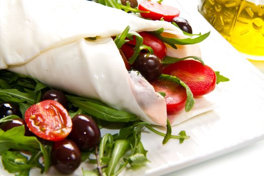 mozzarella roll with tomatoes,olives and salad