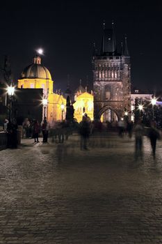 Vertical view of Prague by night on a bridge