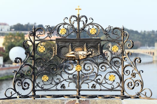 Iron forged grid with St. John Nepomuk carving, Charles bridge, Prague 
