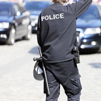 Police officer making the stop sign