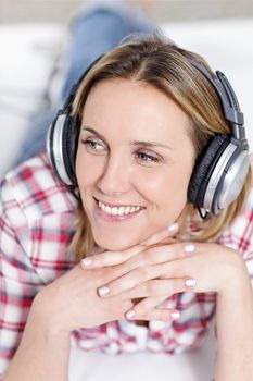 youngblond woman listening music with headphones