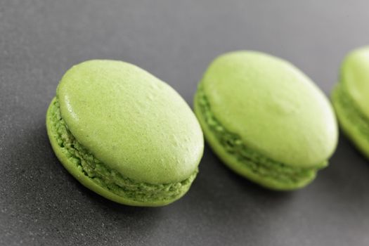 three delicious green macaroons in kitchen