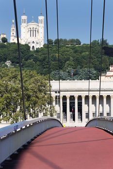 Lyon city with red footbridge on Saone river and basilica