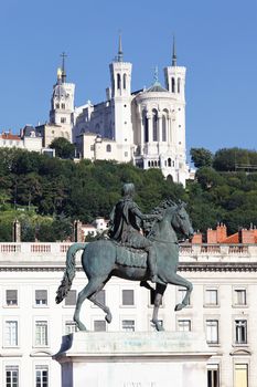 famous statue of Louis XIV and Basilique Fourviere on a background 