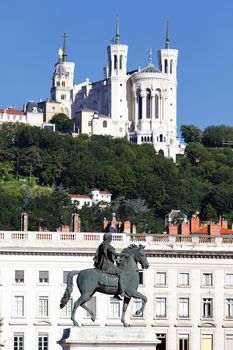statue of Louis XIV and Basilique Fourviere on a background 