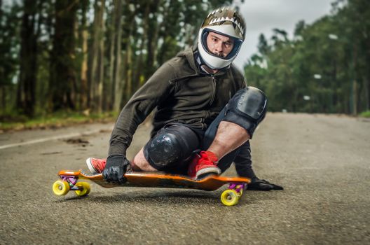 Downhill skateboarder in action on a asphalt road.