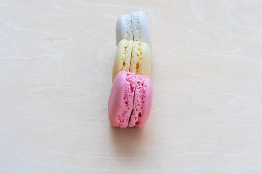 Colorful macaroons on wooden background