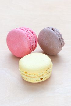 colored macaron on wooden background