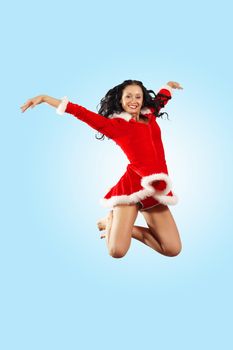 Happy smiling woman in red xmas costume jumping high