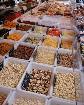 A variety of fruits and nuts being sold on a street market stall