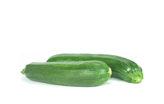 two fresh and green courgettes on white background