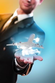 pilot in the form of extending a hand to a flying airplane with sky, clouds and sun