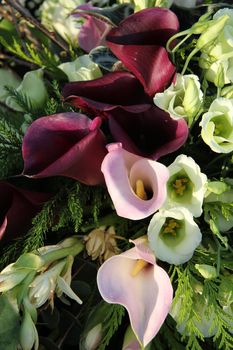Calla Lillies in pink and purple in a wedding arrangement