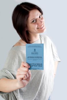 bulgarian immigrant holding uk work permission card for bulgarians and romanians