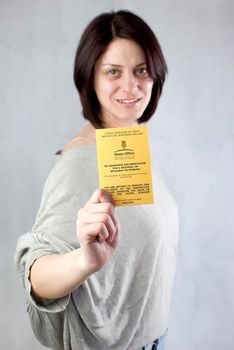 bulgarian immigrant holding uk work permission card for bulgarians and romanians