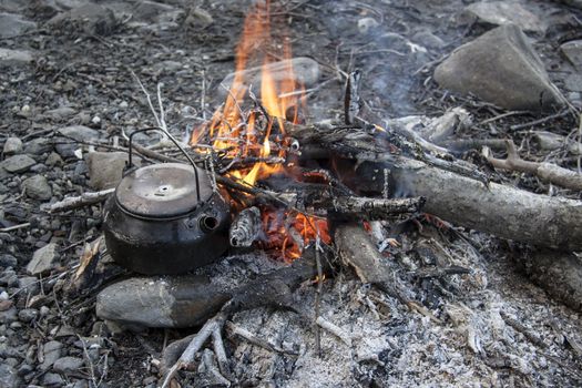 Camp fire in wild mountain 