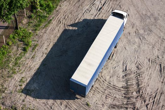 The long truck on parking in a bright sunny day. Top view.