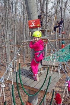 MAGURA, ROMANIA - APRIL 05: Little girl smiling in adventure park. Magura Green Park on April 05, 2013 in Magura, Romania