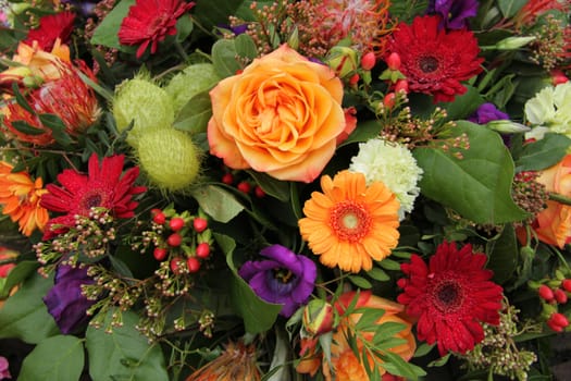 Roses and gerberas in various colors in a mixed floral arrangement