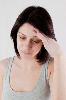 young woman with headache making massage to avoid pain