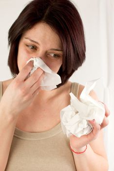 sneezing woman holding tissues, allergy or cold flu concept