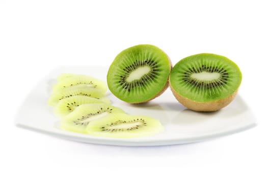 Piece of kiwi fruit and slices over white isolated background
