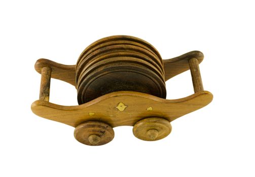 ornamented wooden pallet holder with six round coaster isolated on white background
