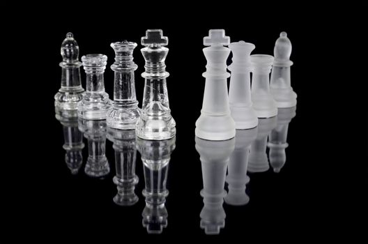 Chess pieces isolated on black background. Beautiful reflection composition