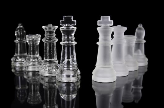 Chess pieces isolated on black background. Beautiful reflection composition