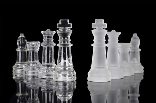 Chess pieces isolated on black background. Beautiful reflection composition