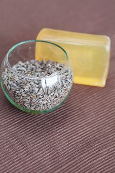 lavender in bowl and soap on brown mat