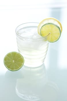 water with lemon and lime in a glass with ice