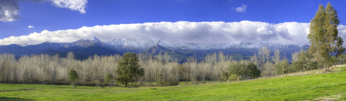 Snowy mountains and green valley in Sierra de Gredos, Avila, Spain