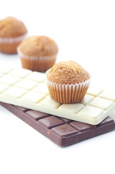 bar of chocolate and muffin isolated on white