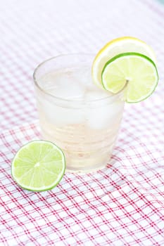 water with lemon and lime in a glass with ice