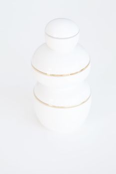 three cosmetic containers on white background