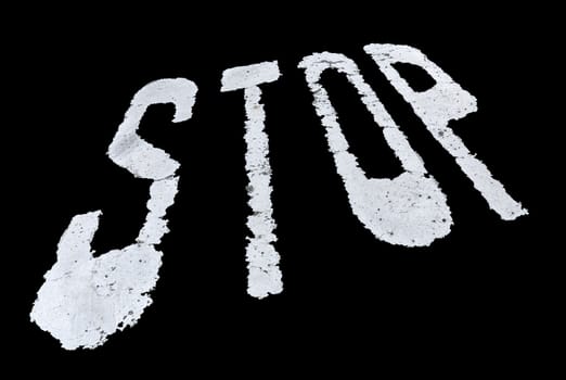 Stop sign painted on the wall isolated over black background