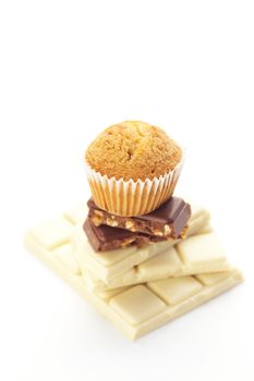 bar of chocolate and muffin isolated on white