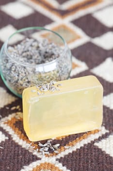 lavender in bowl and soap on ethnic mat