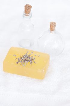 bottles, soap and lavender on a white towel