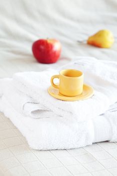 cup of tea,apple and pear on the bed