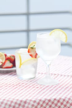 cocktail with ice,lemon, fig and strawberries on a plate