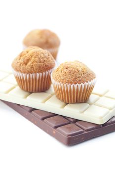 bar of chocolate and muffin isolated on white